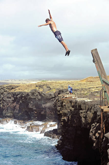Marek Zak of the Czech Republic jumps from the boat hoist at South Point on Thursday. (Laura Ruminski/West Hawaii Today)